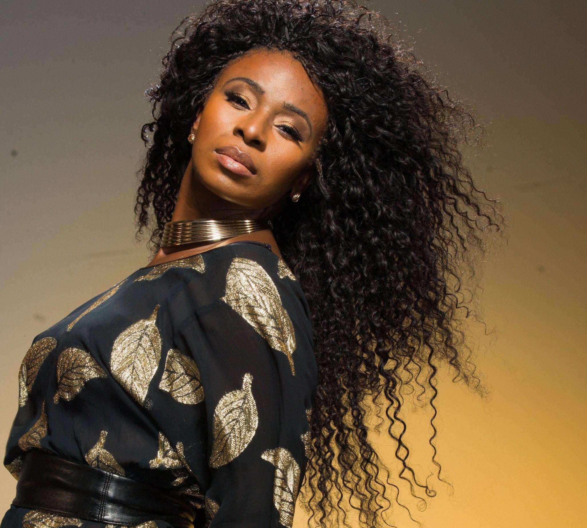 Mushiya wearing 5 bundles of Skarlette Rouge on a weft from Runway Curls Natural Hair Extensions Line, Classic Collection